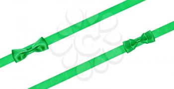 two little green bow knots on two diagonal satin ribbons isolated on white background