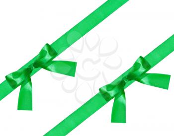 two big green bow knots on two diagonal satin bands isolated on white background