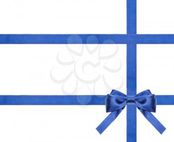one blue satin bow in lower right corner and three intersecting ribbons isolated on horizontal white background