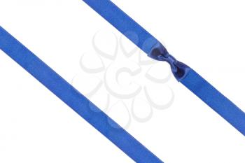 one blue satin bow knot in upper right corner and two diagonal ribbons isolated on horizontal white background