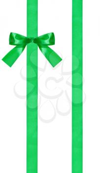 one green bow knot on two parallel satin ribbons isolated on white background
