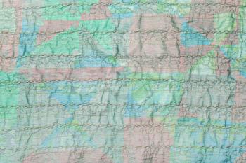 textile background from stitched transparent green silk fabric on patchwork scarf