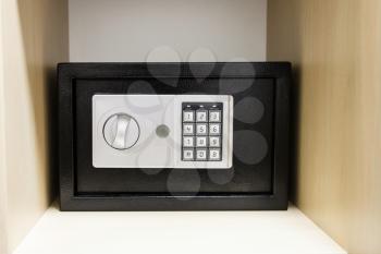 compact safe on shelf of cabinet in hotel room