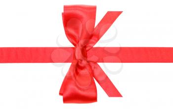 real red silk bow with vertically cut ends on silk ribbon isolated on white background