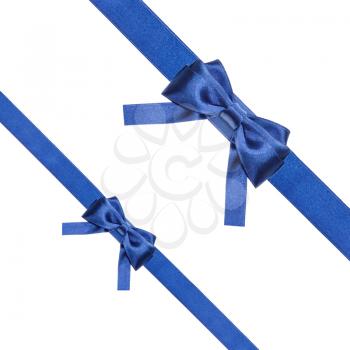 two blue satin bows and two diagonal ribbons isolated on square white background