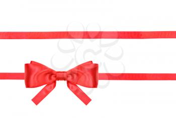 one red satin bow in lower left corner and two horizontal ribbons isolated on horizontal white background