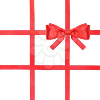 one red satin bow in upper right corner and four intersecting ribbons isolated on square white background