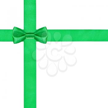 one green bow knot on two crossing satin ribbons isolated on white background