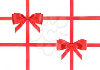 two red satin bows and four intersecting ribbons isolated on horizontal white background