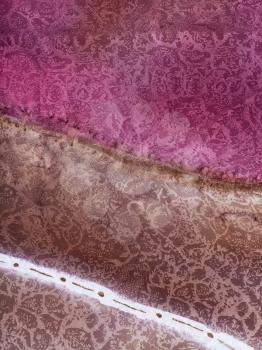 textile background - abstract hand painted magenta and brown striped pattern on silk batik