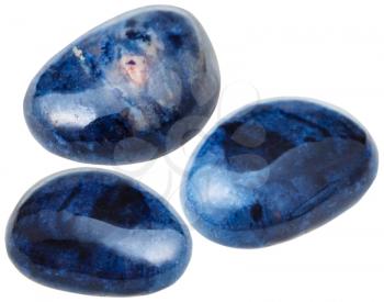 natural mineral gem stone - three Dumortierite gemstones isolated on white background close up