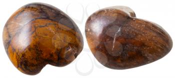 natural mineral gem stone - two tiger eye's stone gemstones isolated on white background close up