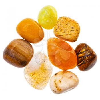 pile of yellow and brown natural mineral gemstones isolated on white background