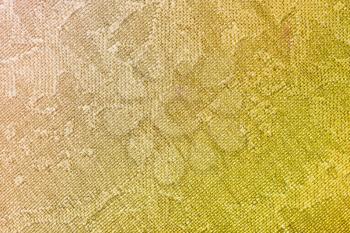 textile background - brown and yellow batik silk fabric with Jacquard weave pattern of threads close up