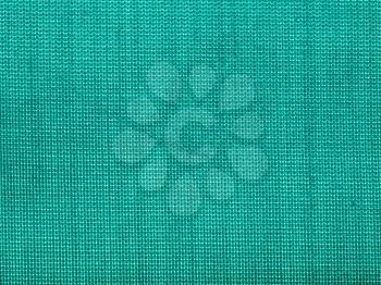 textile background - green silk Taffeta fabric with weave pattern of threads close up
