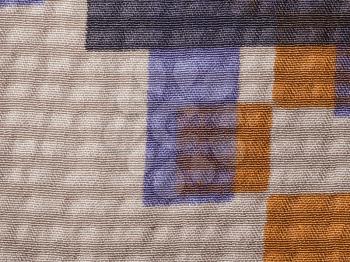 textile background - brown and blue silk fabric with crape jacquard weave pattern of threads close up