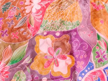 textile background - abstract hand painted leaves and flowers on pink and purple silk batik
