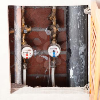 new mechanical water meters on pipes in niche