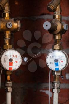hot and cold mechanical water meters on pipes