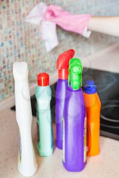 House cleaning - plastic bottles with detergents on kitchen worktop