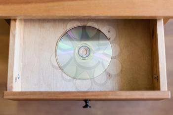 above view of disk in open drawer of nightstand