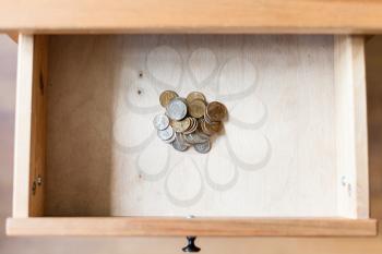 above view of pile of russian coins in open drawer of nightstand