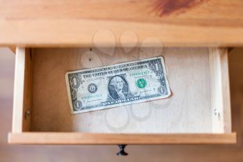 above view of one dollar banknote in open drawer of nightstand