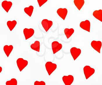 red hearts cut out from paper on white background