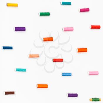 spools of sewing color threads on white background