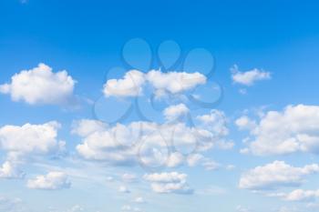 many small white clouds in blue sky in sunny summer day