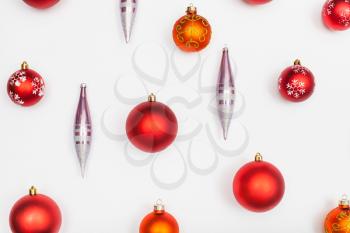 red christmas balls and glass icicles on white background