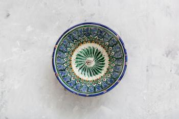 top view of traditional central asian bowl on gray concrete plate