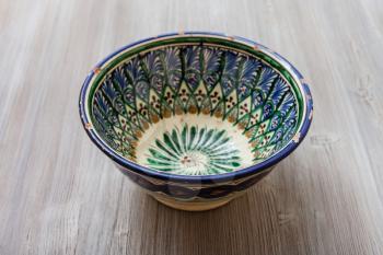 one traditional central asian bowl on gray brown board