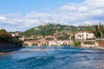 travel to Italy - view of Ponte Pietra Roman arch bridge (Stone Bridge, Pons Marmoreus) crossing the Adige River in Verona,