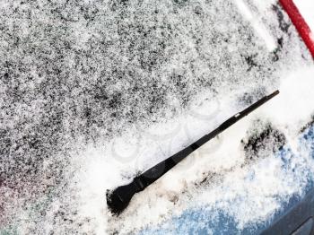 frozen rear window of car in winter day