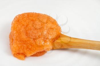 salty caviar of common carp in wooden spoon on white plate