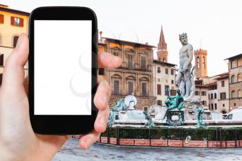 travel concept - tourist photographs Piazza signoria with Neptune Fountain in Florence city on smartphone with cut out screen with blank place for advertising in Italy