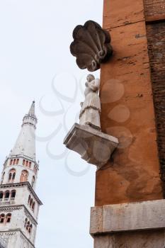 travel to Italy - figure The Bonissima, it is medieval statue on the corner of the Town Hall and Torre della Ghirlandina in Modena city