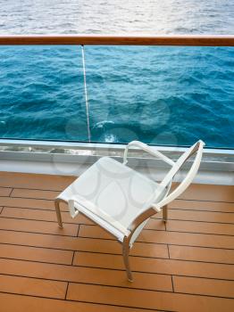 empty chair on balcony of cruise liner