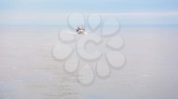 boat with pilot in Baltic sea in autumn morning mist
