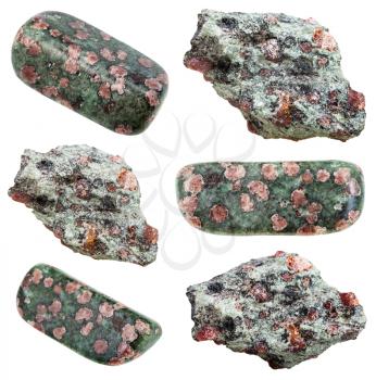 collection of various tumbled and raw Eclogite mineral stones with garnet (red almandine, pyrope) in omphacite (greyish-green) matrix isolated on white background