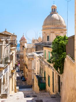 travel to Italy - street and view of dome of Cathedral in Noto city in Sicily