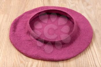 felting workshop - handmade felt beret is drying on wooden table