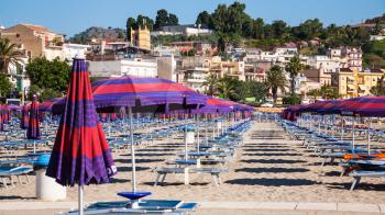 GIARDINI NAXOS, ITALY - JULY 8, 2011: urban beach of Giardini Naxos town in summer morning. Naxos was founded by Thucles the Chalcidian in 734 BC, and since 1970s it has become a seaside-resort
