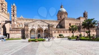 PALERMO, ITALY - JUNE 24, 2011: tourists on square and Palermo Cathedral. It is the cathedral church of Roman Catholic Archdiocese of Palermo dedicated to the Assumption of the Virgin Mary