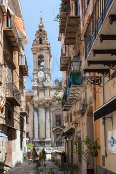 PALERMO, ITALY - JYNE 24, 2011 - tourists on via orologio and view of bell tower of Chiesa di Sant Ignazio in Palermo city. The church was built starting in 1598.
