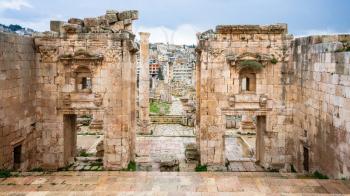 Travel to Middle East country Kingdom of Jordan - view of Jerash city through Gates of Artemis temple in ancient Gerasa town in winter