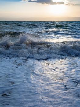 Travel to Middle East country Kingdom of Jordan - sundown and surf at Dead Sea in winter evening