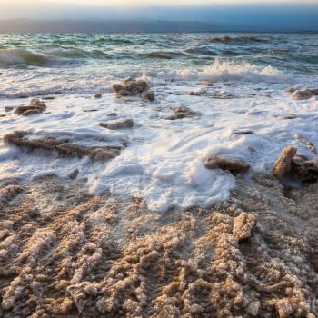 Travel to Middle East country Kingdom of Jordan - crystalline coast of Dead Sea on winter evening