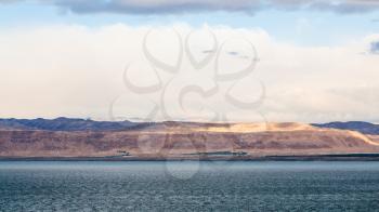 Travel to Middle East country Kingdom of Jordan - view of Dead Sea and Jerusalem city in Israel from Jordan shore on winter dawn